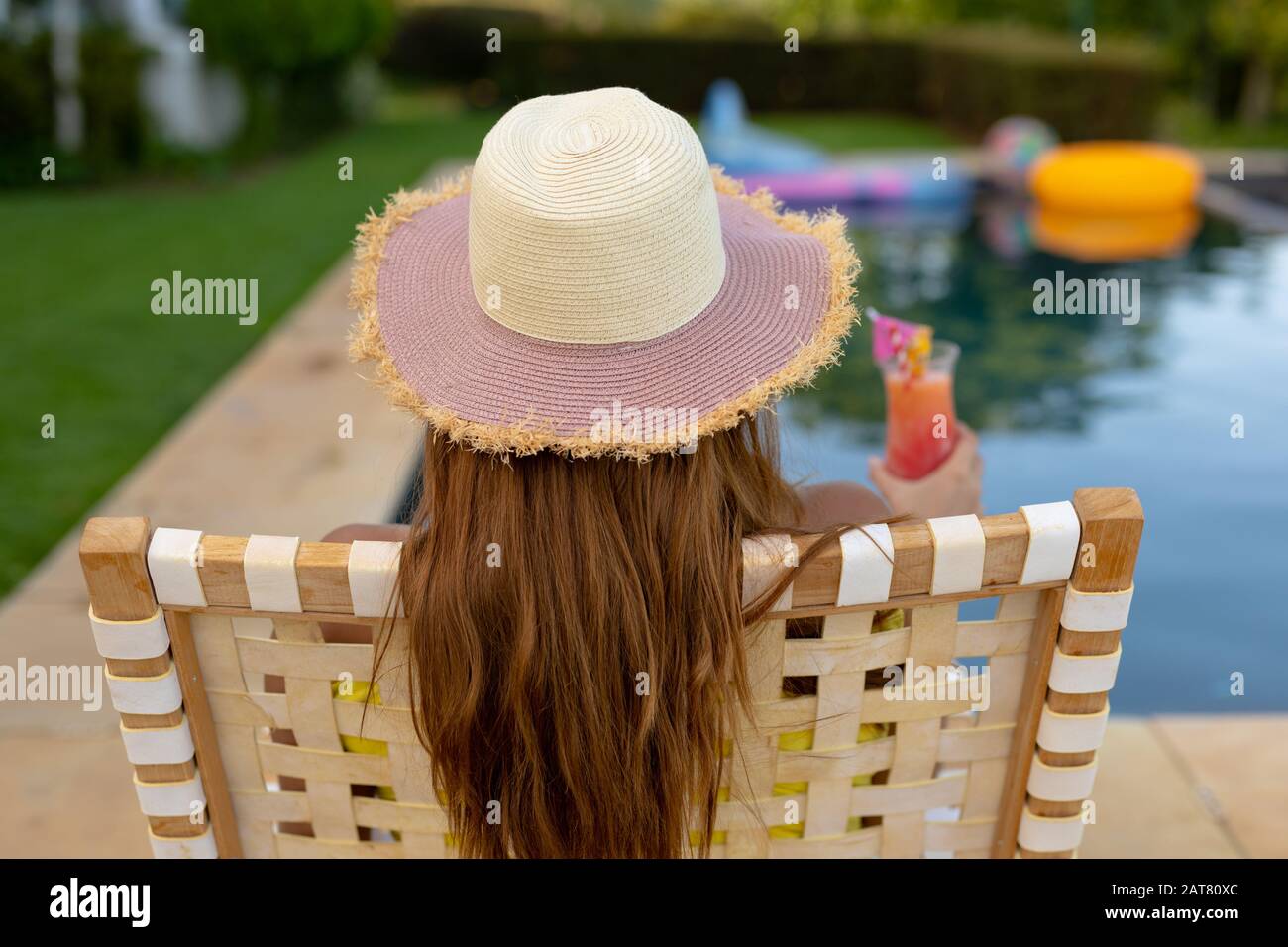 Young woman relaxing near swimming pool on a sunny day Stock Photo - Alamy