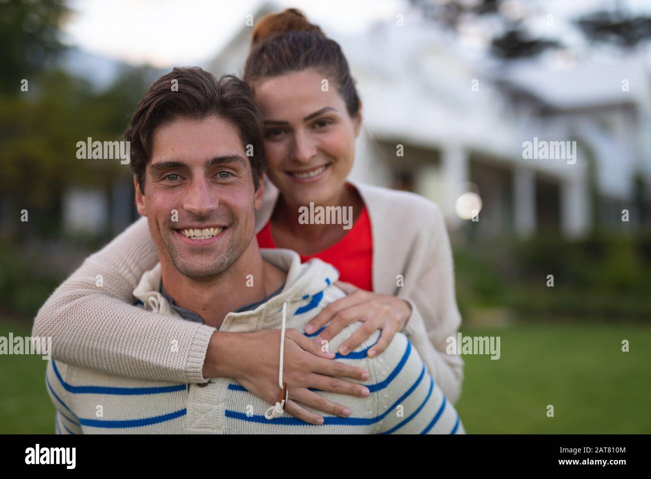 Young couple with arms around each other hi-res stock photography and ...