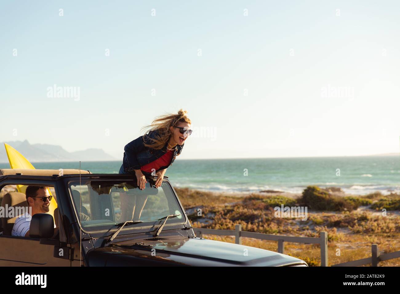 Couple in a car at the beach Stock Photo