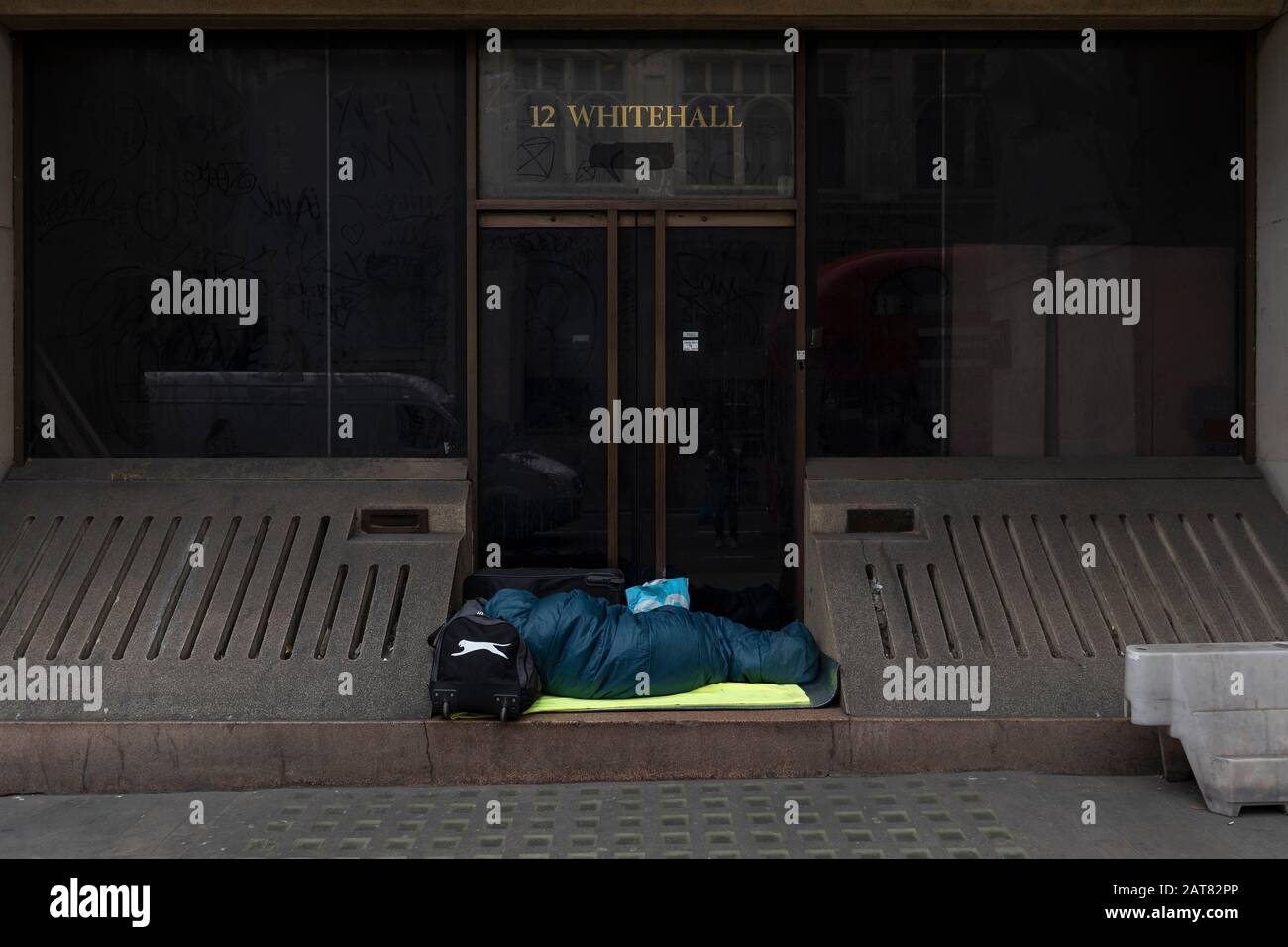 London, UK. 31 January 2020. On the day Britain formerly leaves the EU, a homeless person sleeps in a doorway outside number 12 Whitehall. Stock Photo