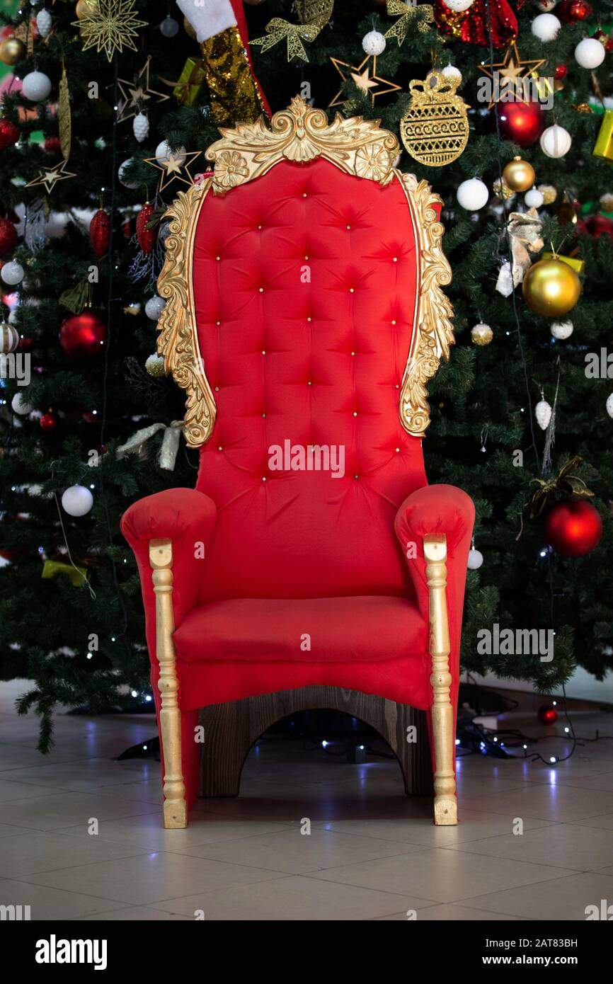 Red throne at the christmas tree. Armchair for Santa Claus Stock Photo