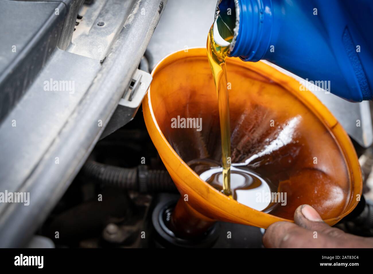 New engine oil is being poured into engine at automobile workshop Stock Photo