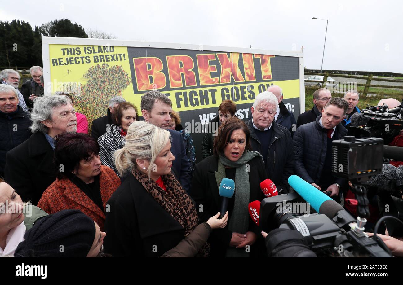 Sinn Fein leader Mary Lou McDonald (centre) and deputy leader Michelle O'Neiil (centre left) arrive for the unveiling of a Border Communities Against Brexit poster at a demonstration in Carrickcarnon on the Irish border, ahead of the UK leaving the European Union at 11pm on Friday. Stock Photo
