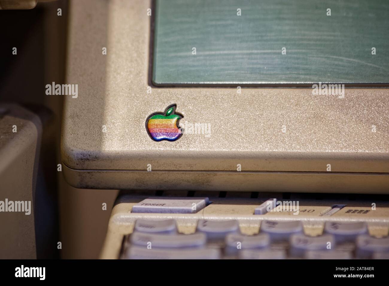 Retro Apple Logo on fourth model of Apple II series Apple IIc personal computer with flat panel display. Stock Photo