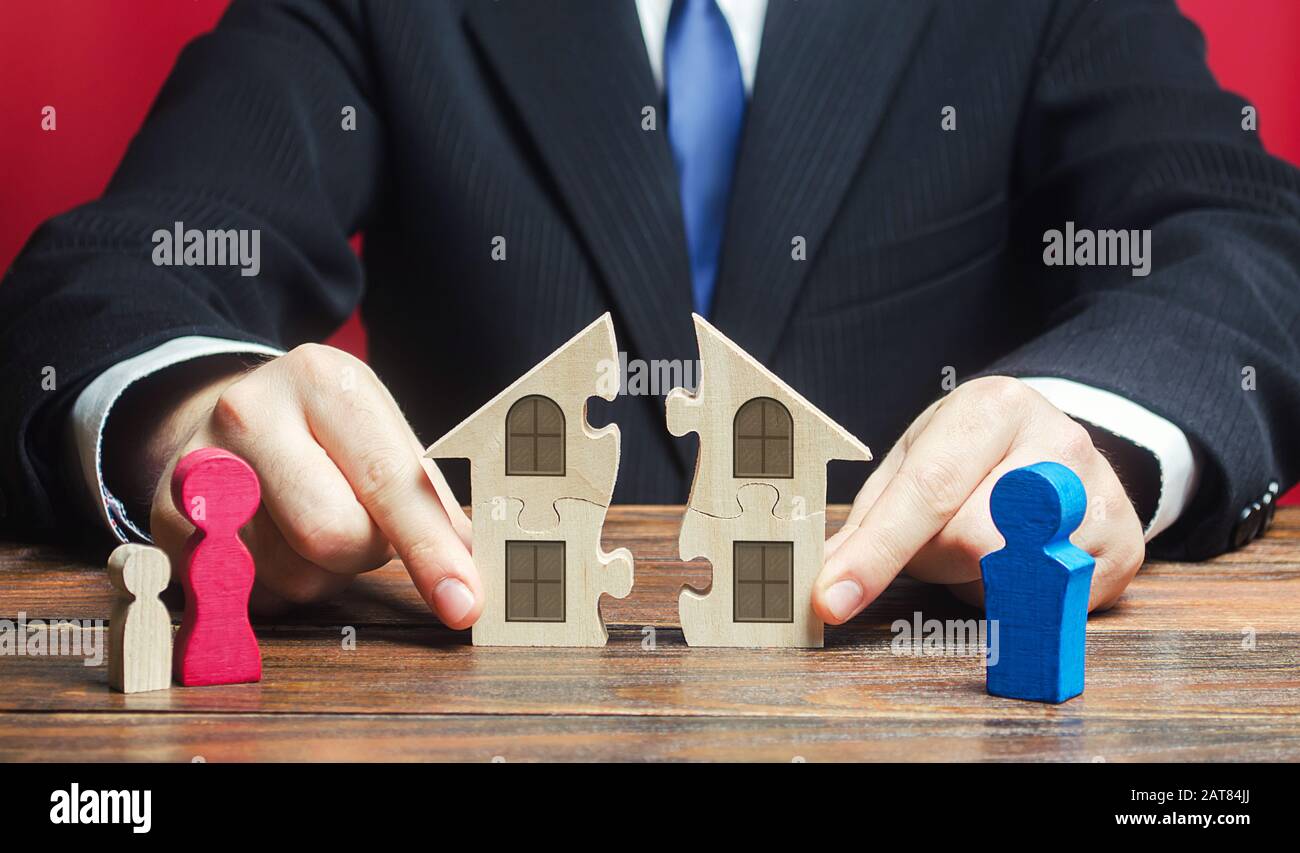 Lawyer controls separation and connection of house between husband and wife. Marriage contract. Former spouses in divorce process. Conflict resolution Stock Photo