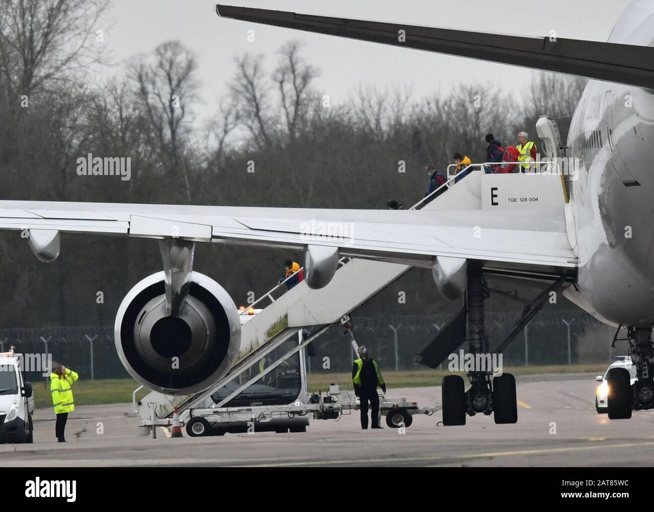 Passengers disembark from the plane carrying British nationals from the coronavirus-hit city of Wuhan in China, arrives at RAF Brize Norton in Oxfordshire. Stock Photo