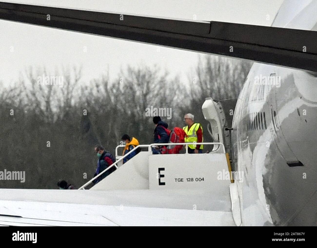 Passengers disembark from the plane carrying British nationals from the coronavirus-hit city of Wuhan in China, arrives at RAF Brize Norton in Oxfordshire. Stock Photo