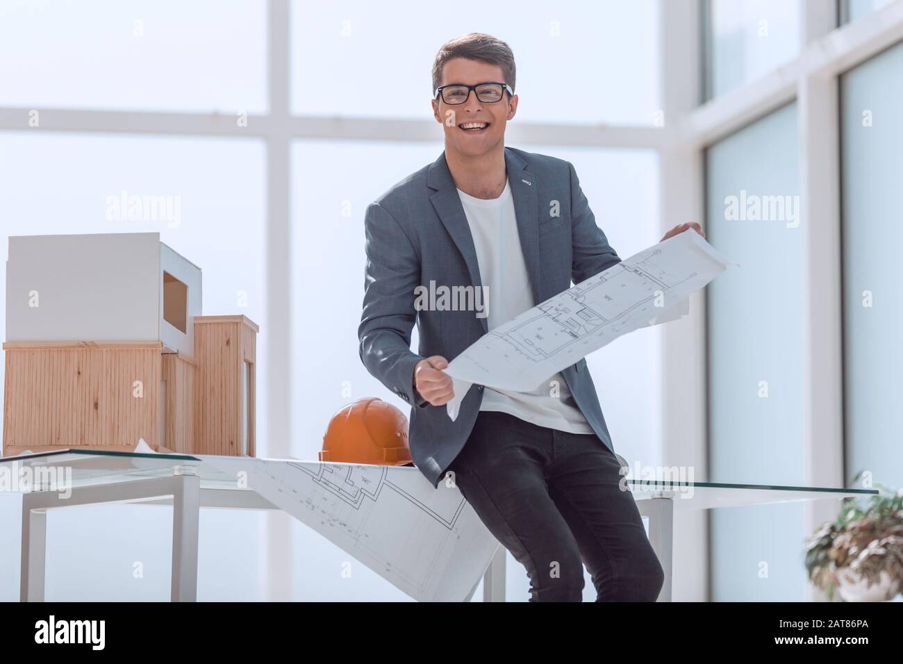 smiling architect with a drawing of a new project Stock Photo - Alamy