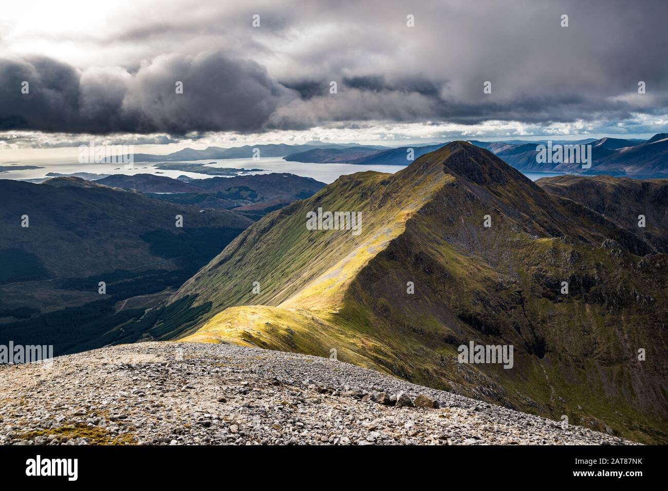 The peak of Sgorr Dhonuill (Beinn a'Bheithir) on an autumn day with clouds gathering ofer the coastline. Glencoe, Scotland. Stock Photo