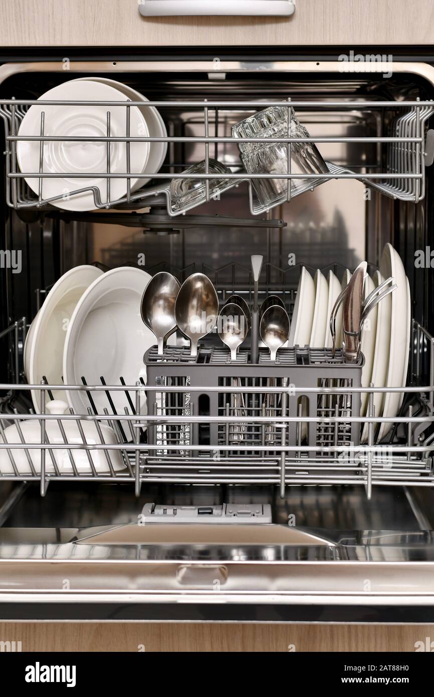 Clean Dishes In A Fragment Of A Dishwasher Built Into The Cabinet