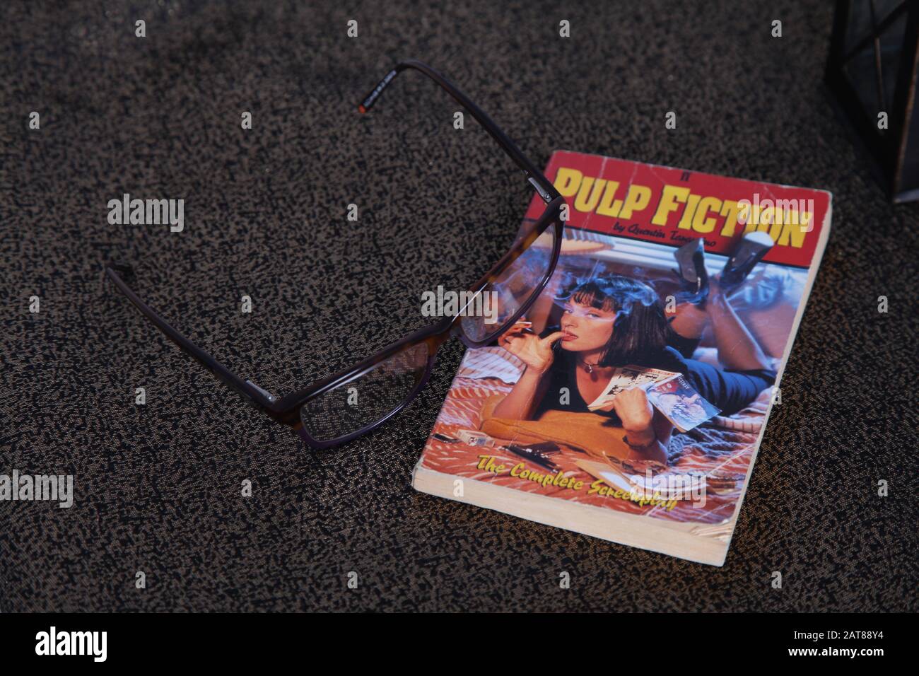 Pulp Fiction the Complete Screenplay crime noir paperback book, Instagram style with glasses spectacles Stock Photo
