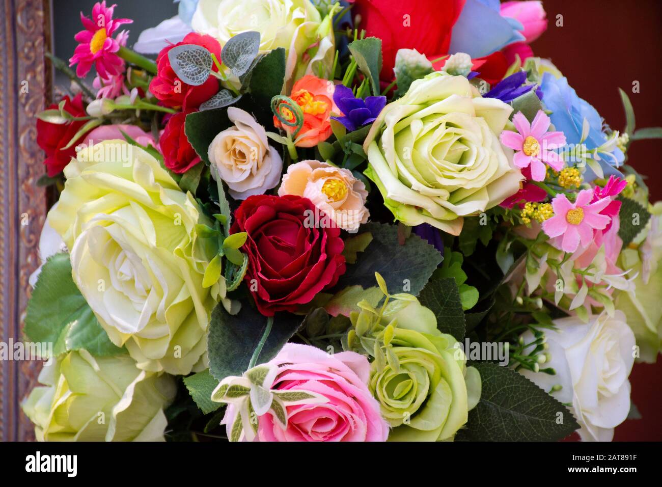 Colorful plastic roses and other flowers for decoration and furniture ...