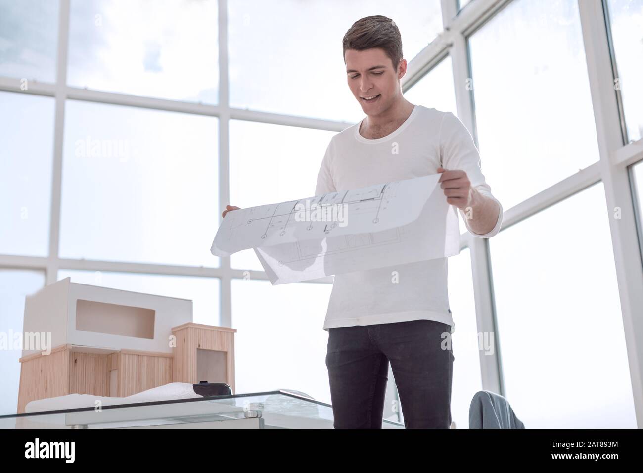 young architect reading a drawing of a new proje Stock Photo