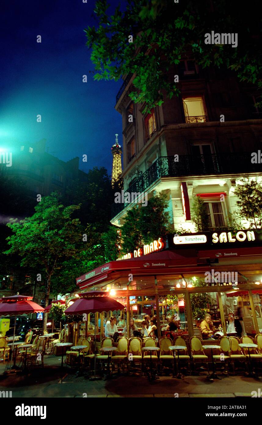 PARIS CAFÉ AT NIGHT TIME WITH THE EIFFEL TOWER IN THE BACKGROUND - PARIS CAFÉ TERRASSE - SILVER IMAGE © Frédéric BEAUMONT Stock Photo