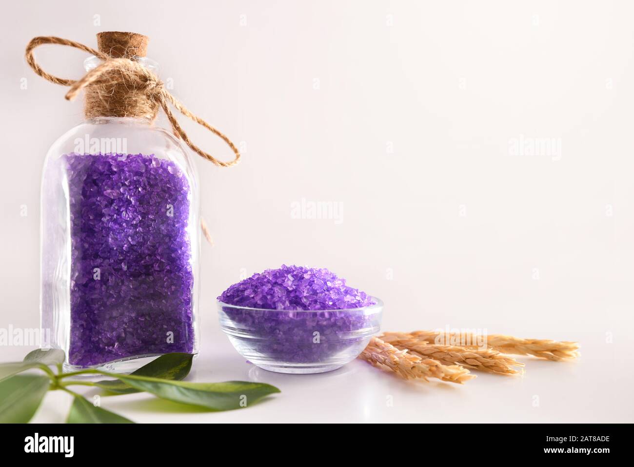 Lilac bath salts on white table and white isolated background. Front