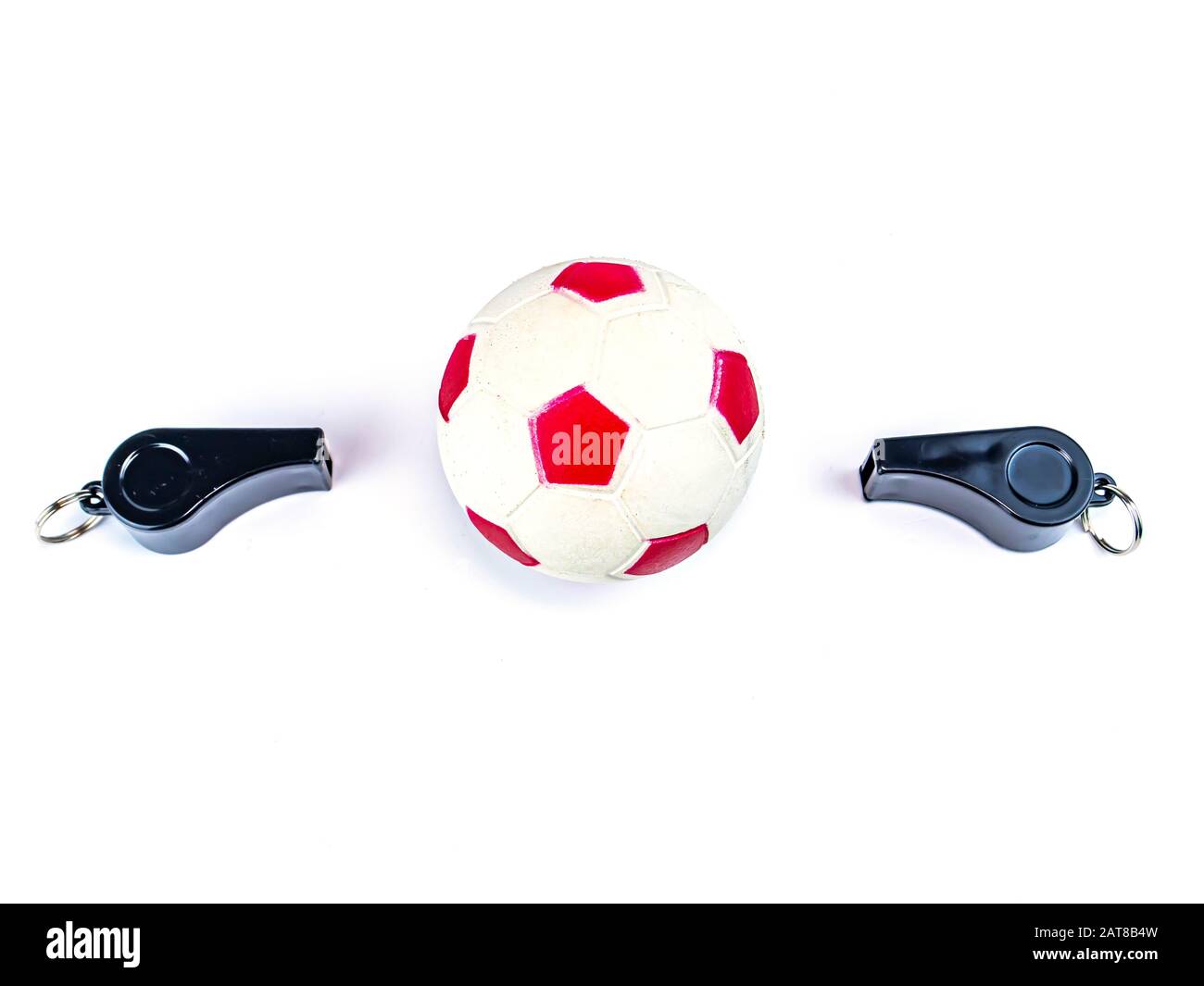 Soccer ball and whistle of a soccer referee on a white background. Football. Championship. World. Europe. Referee. Place for text. Stock Photo