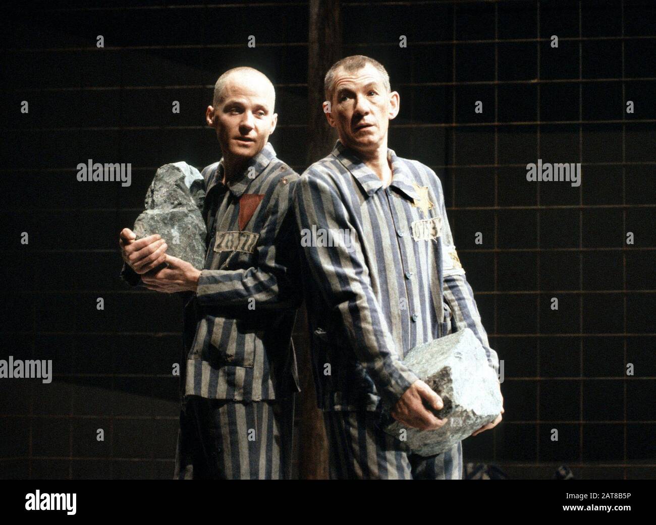 Michael Cashman (Horst) and Ian McKellen (Max) in BENT by Martin Sherman directed by Sean Mathias at the Lyttelton Theatre, National Theatre (NT), London in 1990. Sir Ian Murray McKellen, born 1939, Burnley, England. English stage and film actor. Co-founder of Stonewall, gay rights activist, knighted in 1990, made a Companion of Honour 2007. Stock Photo