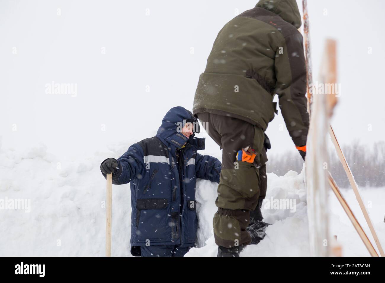 Two workers in overalls at a construction site Stock Photo