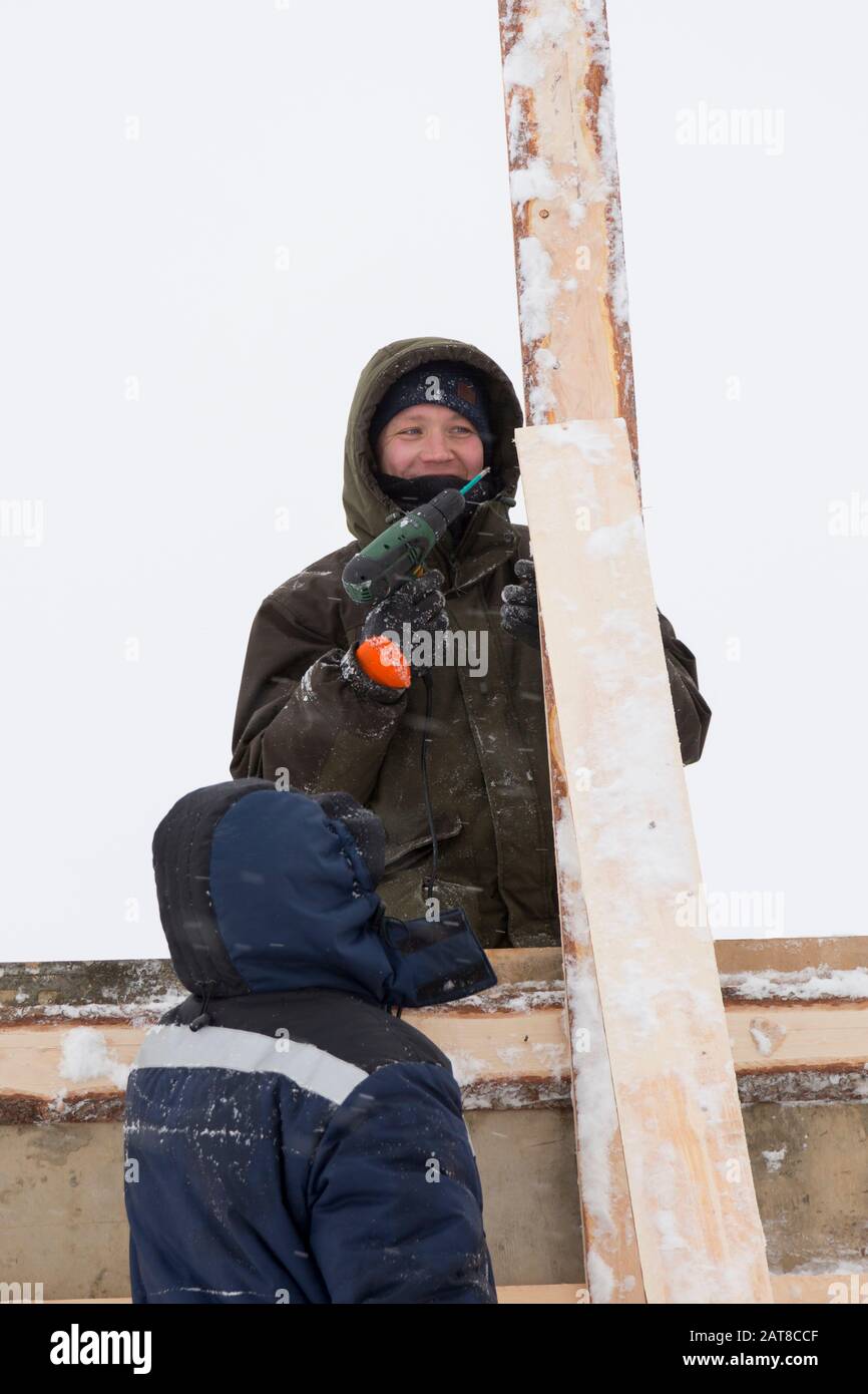 Two workers in overalls at a construction site Stock Photo