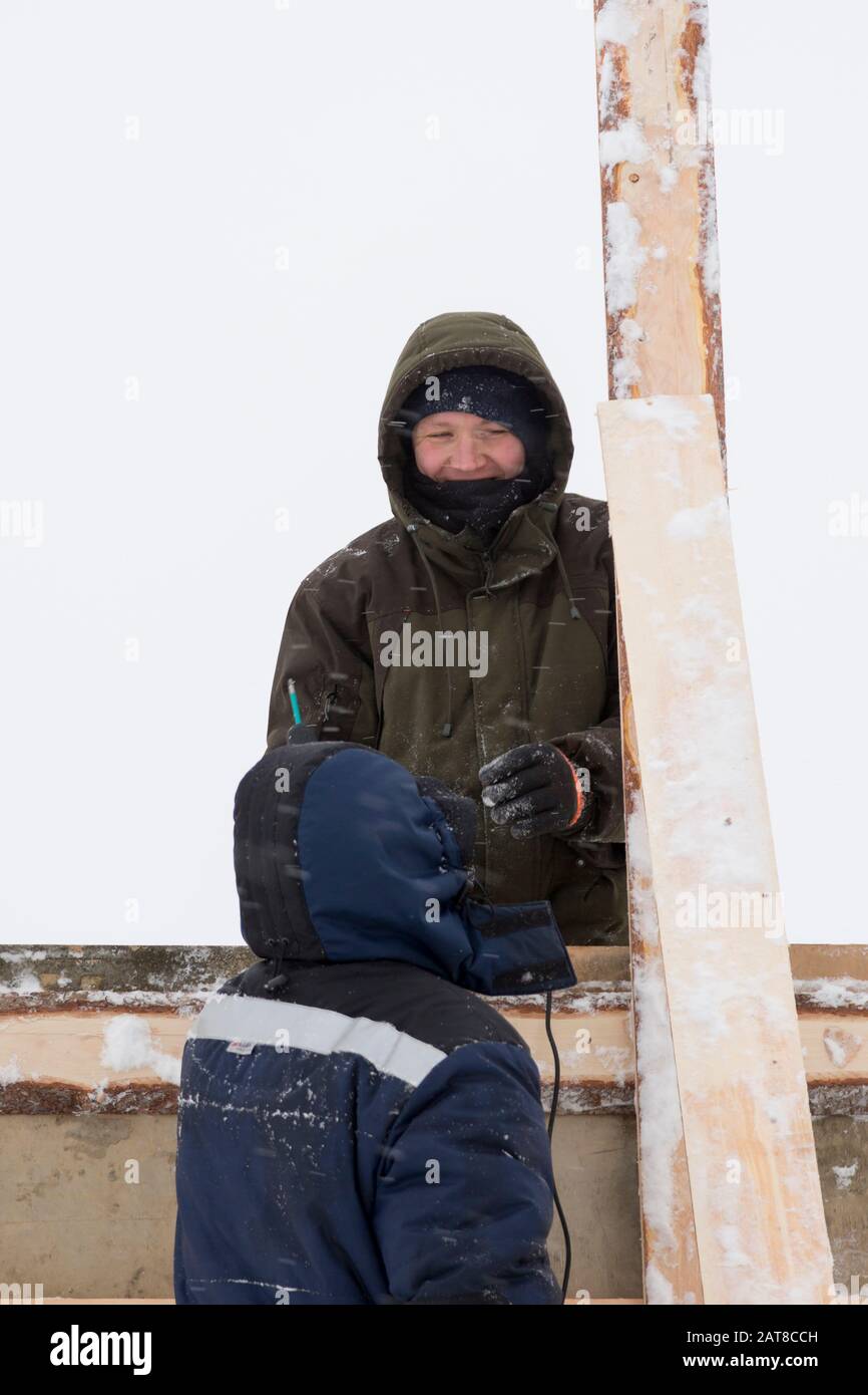 Two workers in overalls at a construction site Stock Photo