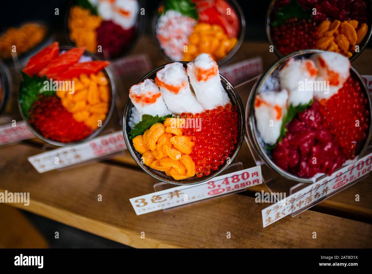 High angle close up of plastic bowls of Japanese food on display outside of a restaurant. Stock Photo