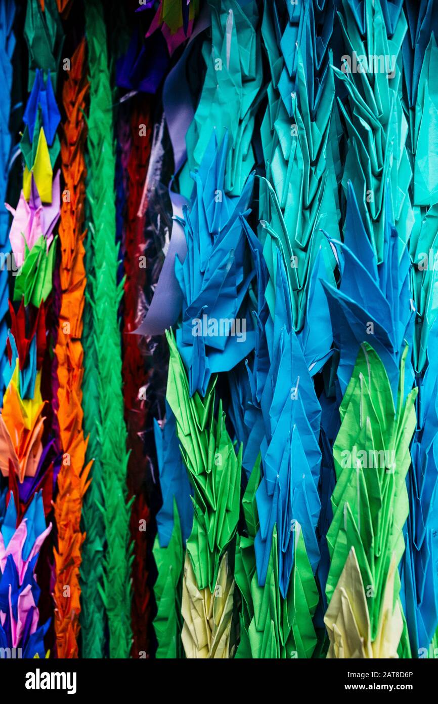 Close up of colourful origami cranes, a symbol of peace, decorating an