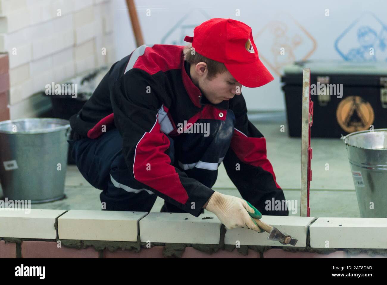 Young bricklayer performs a task of competition Stock Photo - Alamy