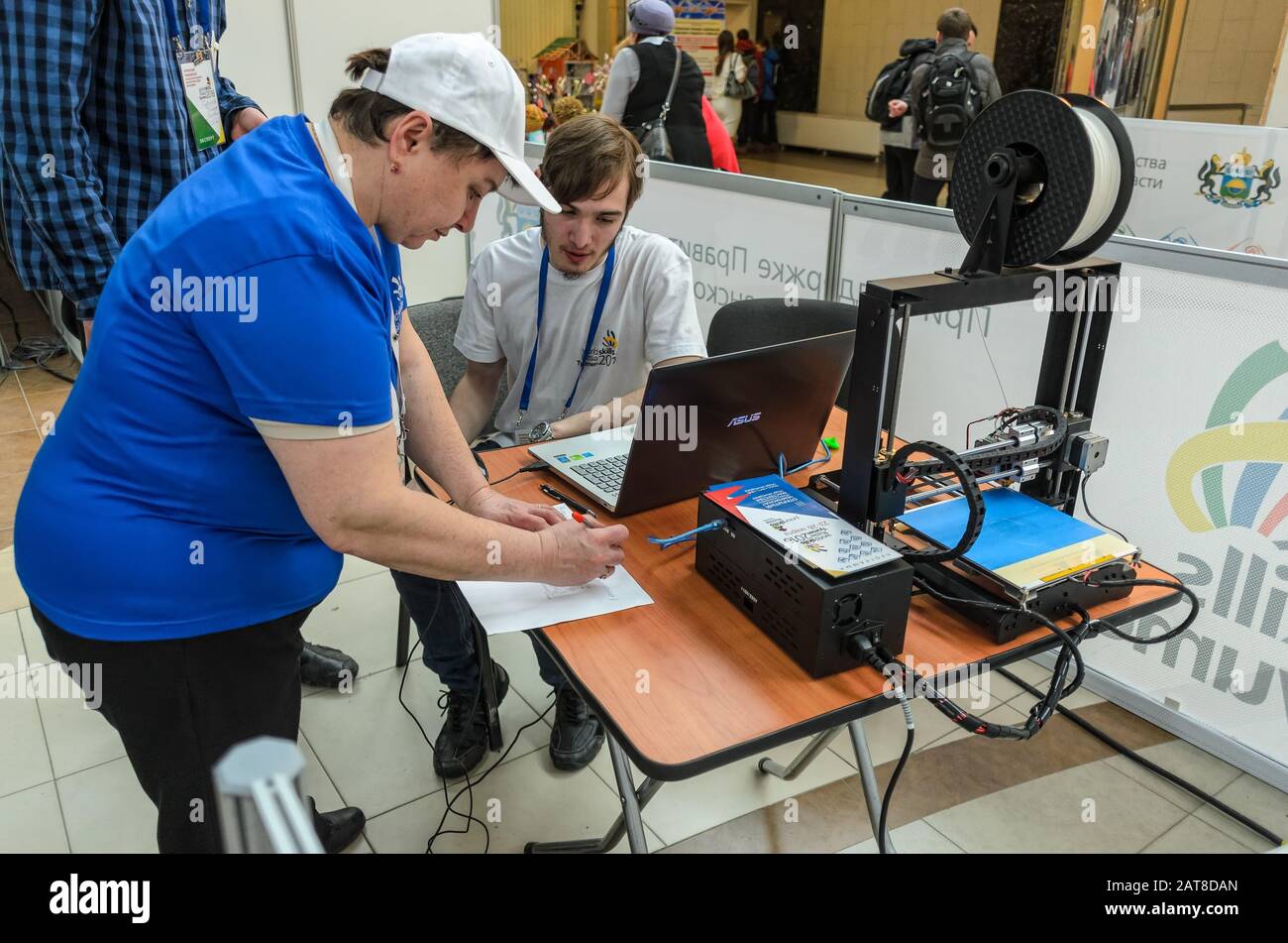 The participant receives task for 3D printer Stock Photo