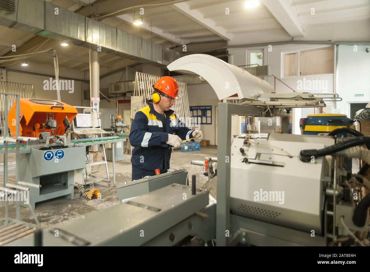 Worker produces a window from plastic Stock Photo