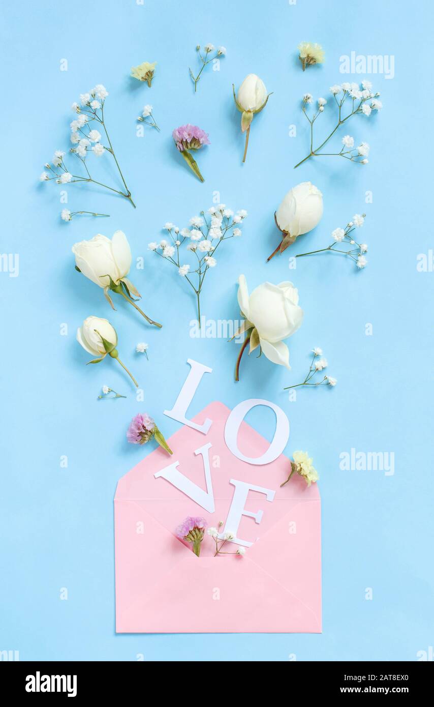 Word Love Flowers And Pink Envelope On A Light Blue Background