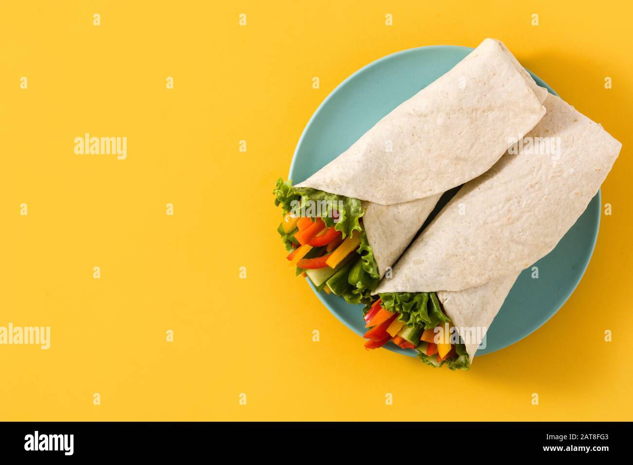Vegetable tortilla wraps on yellow background Stock Photo Alamy