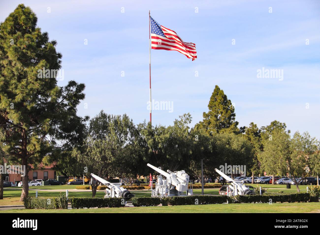 San Diego CA 1302020 Large American flag flying next to old former Navy 50 caliber guns on