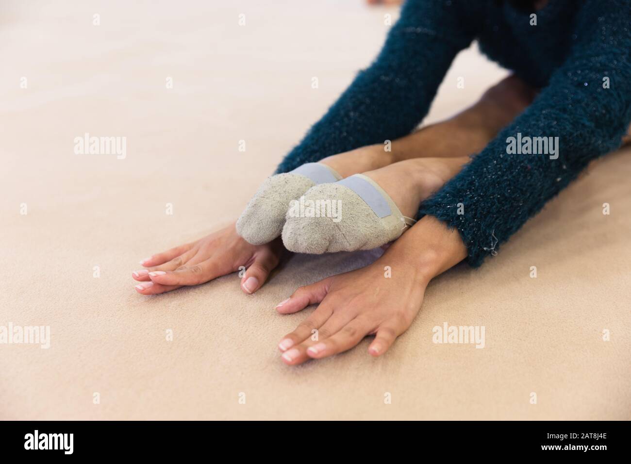 Gymnast stretching at the gym Stock Photo - Alamy