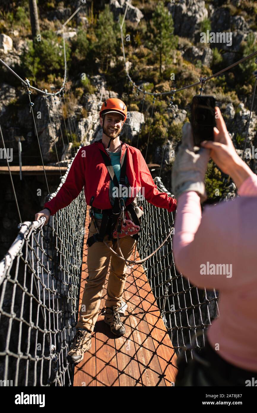 Couple taking pictures on a bridge Stock Photo