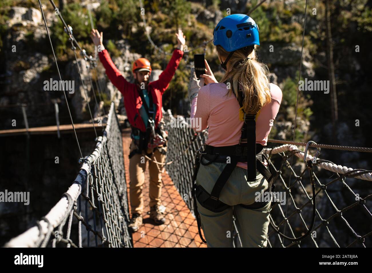 Couple taking pictures on a bridge Stock Photo