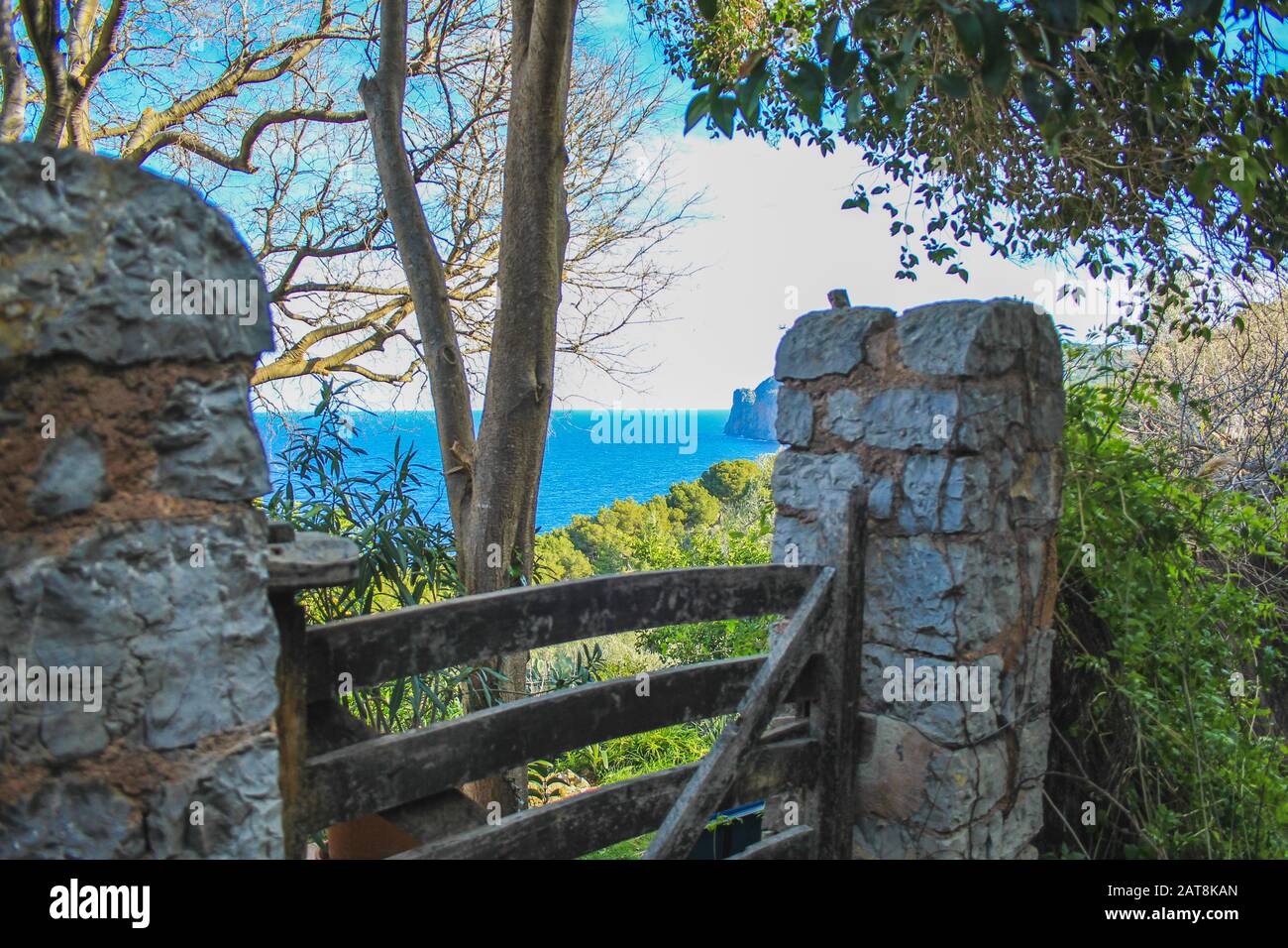 Wooden gate in spanish style garden located by the sea in Mallorca