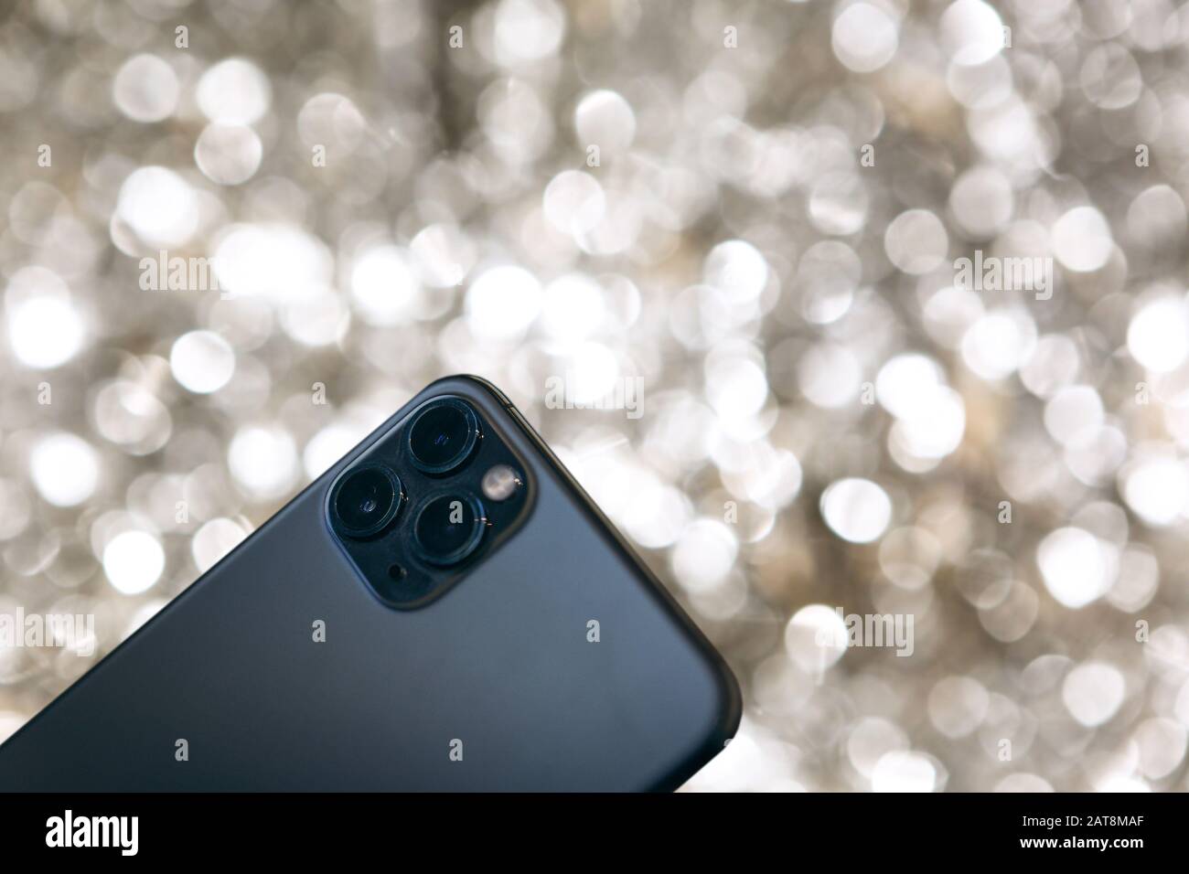 Modern phone with a triple camera on a silver background Stock Photo ...