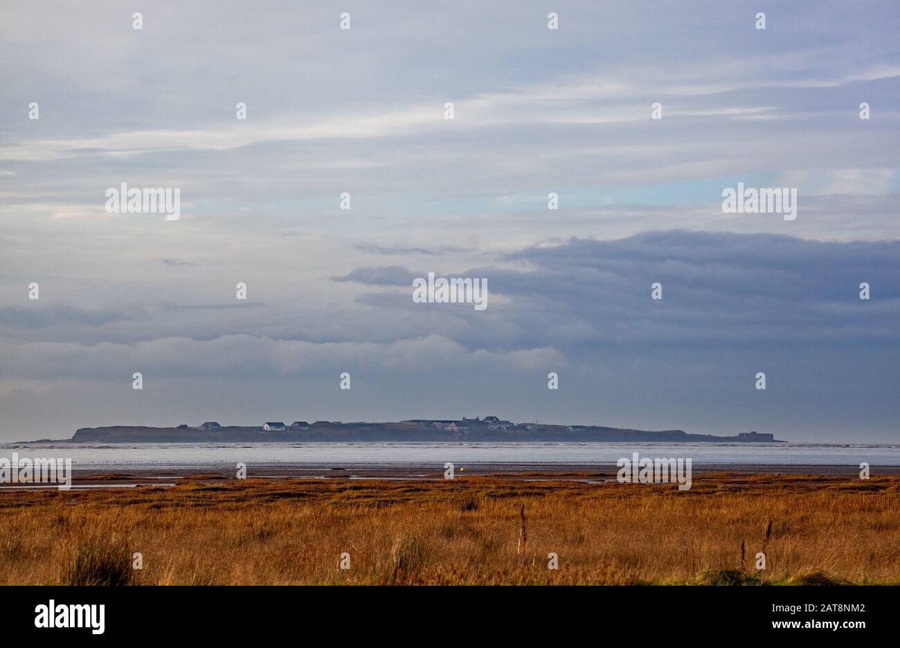 Hilbre Island in the Dee estuary seen from the beach at West Kirby on the Wirral Peninsula Stock Photo