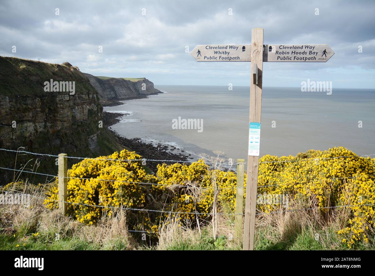 A trail sign between Whitby and Robin Hood's Bay along the Cleveland Way, a hiking path in North York Moors National Park, Yorkshire, England, U.K. Stock Photo
