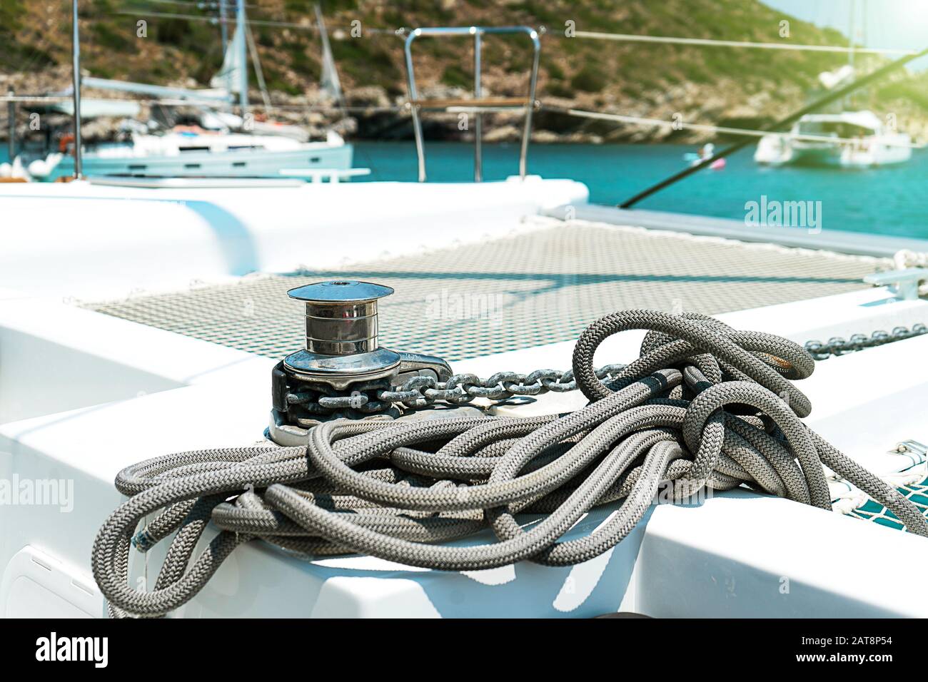 Yacht winch and cable on a sailing yacht. Rope wound on the small windlass of the yacht ship. Greece holiday. Stock Photo