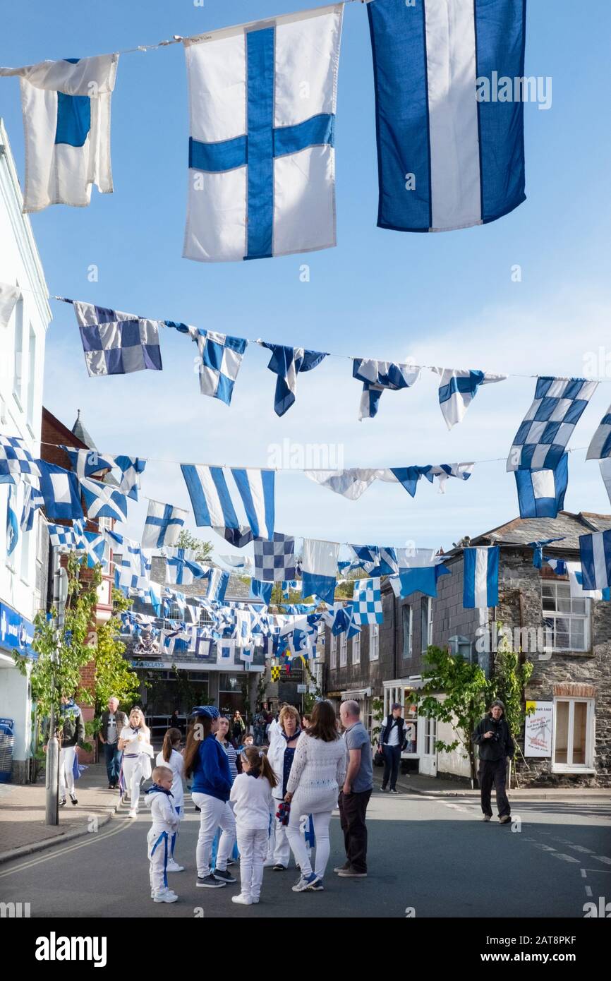 Traditional blue and white flags hanging in street during the Obby Oss celebrations, Padstow, Cornwall, UK Stock Photo
