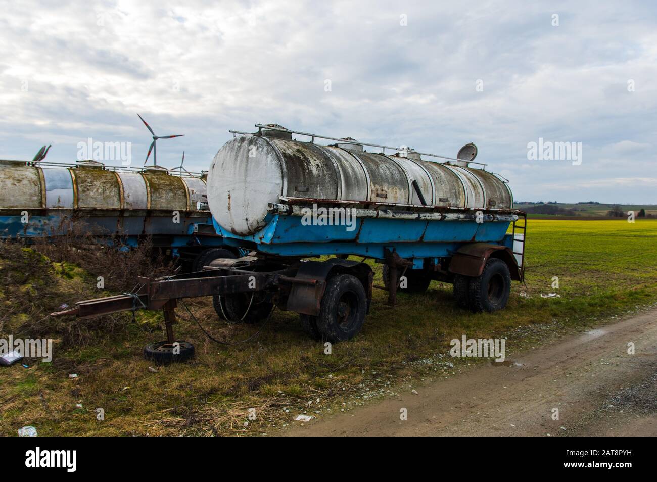 rusty and decaying milk tank trailers as they were used in the German Democratic Republic GDR Stock Photo