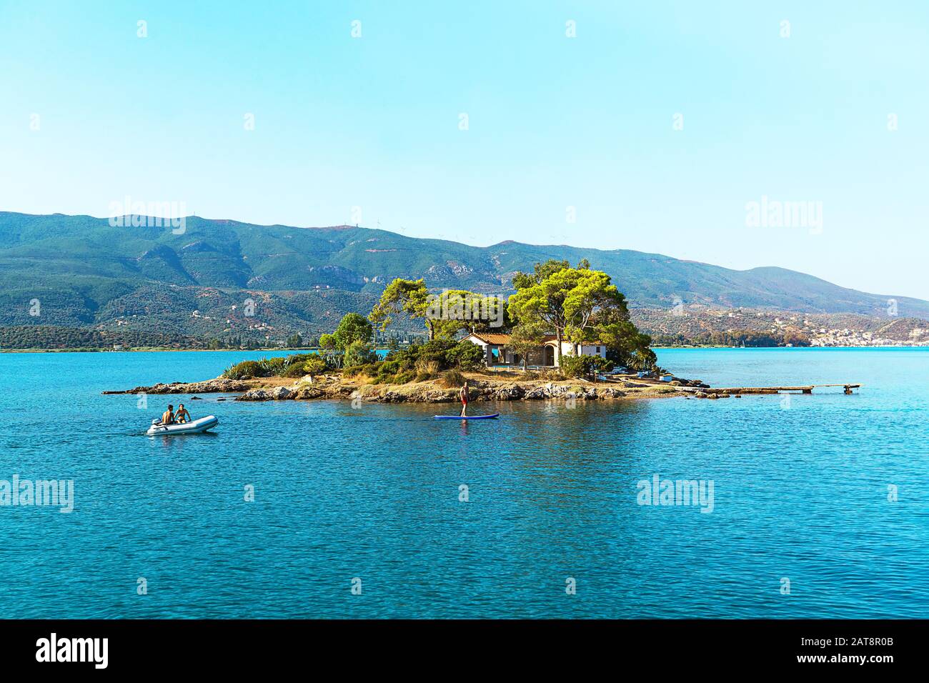 Happy family and friends resting on turquoise water of the Aegean Sea, Greece. Famous sailing travel destination, summer scenery in Europe. Stock Photo