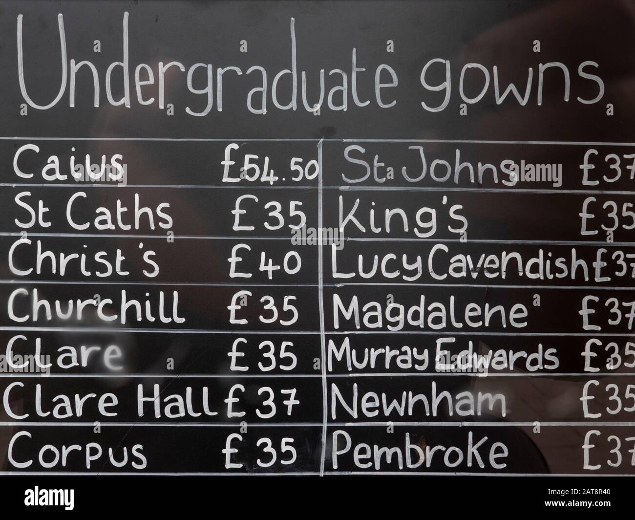 A list of prices for undergraduate gowns for various colleges at Cambridge University in the shop window at Ryder and Amies a university clothes suppl Stock Photo