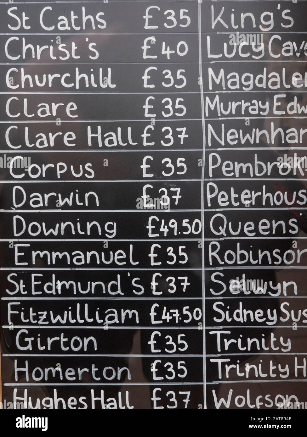 A list of prices for undergraduate gowns for various colleges at Cambridge University in the shop window at Ryder and Amies a university clothes suppl Stock Photo