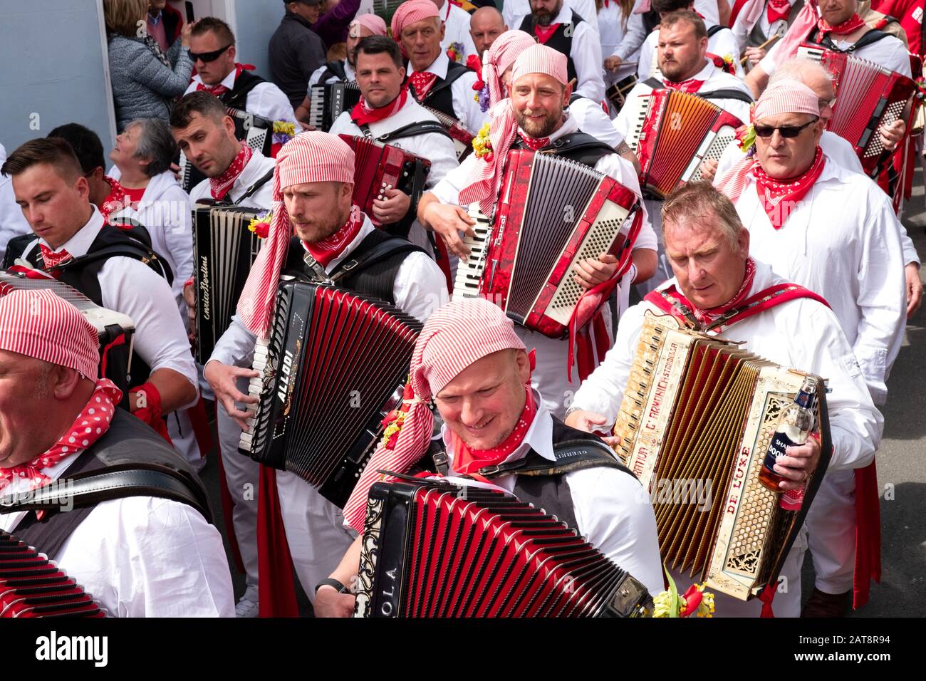Accordion player playing accordions and following the red ribbon Obby
