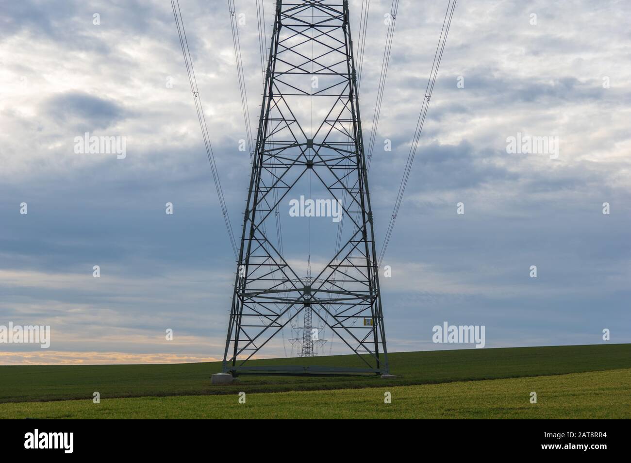 power transmission tower on background of cloudy sky Stock Photo - Alamy