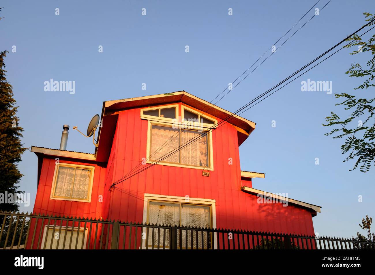 Sunset over a red house of Curacautín. Araucania region. Chile. Stock Photo