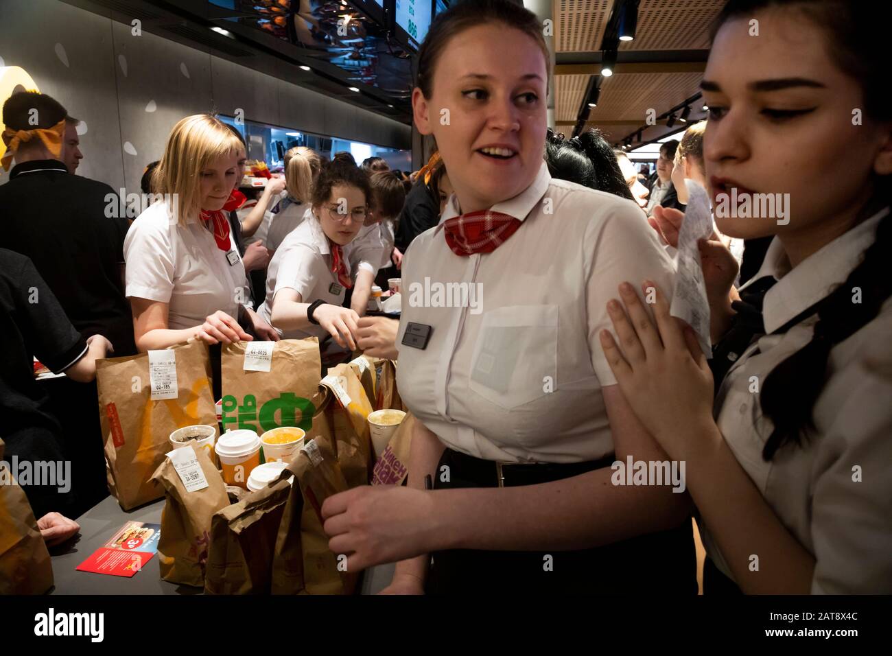 Moscow, Russia. 31st of January, 2020 McDonald’s workers prepare food for visitors inside the first McDonald's restaurant in Russia, on Pushkin Square of Moscow on the Day of the celebration of the 30th anniversary of the opening of the first restaurant of the company in the Soviet Union. On the opening day of the first fast food restaurant in USSR, McDonald's, near the Pushkinskaya metro station, on January 31, 1990, visitors had to stand for several hours Stock Photo