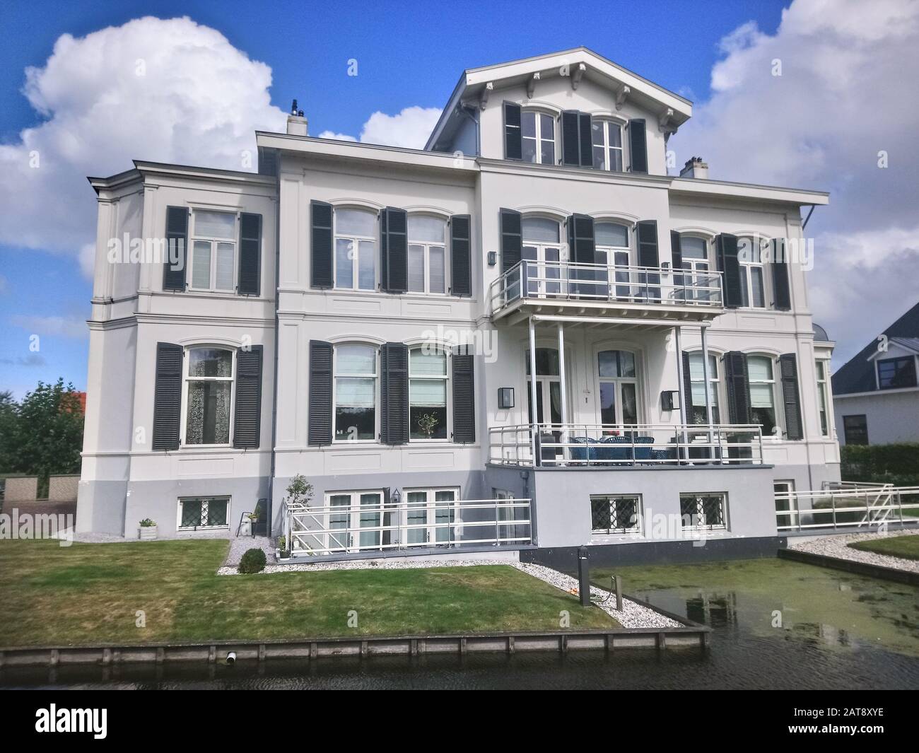 Villa in classic style with beautiful blinds or shutters. Detailed view of a traditional villa